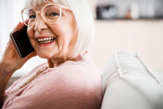 Senior woman having phone conversation and smiling